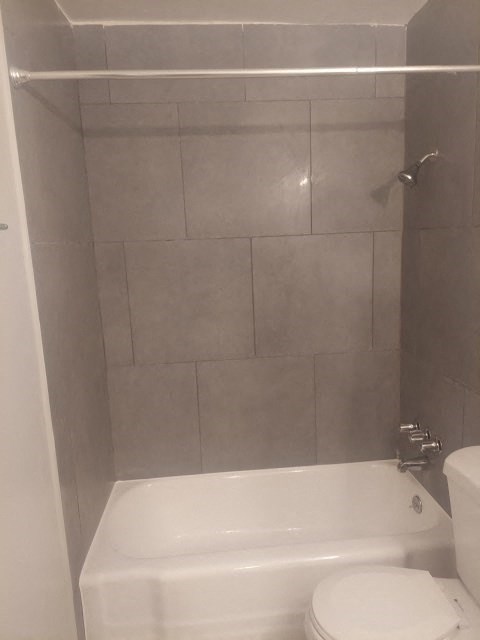 a bathroom with a toilet and a bath tub