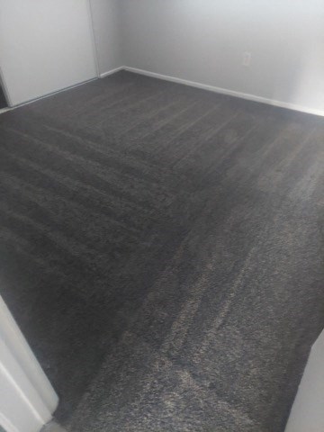 a gray carpeted floor in a white room