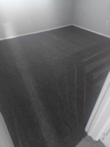 the floor of a room with a gray carpet