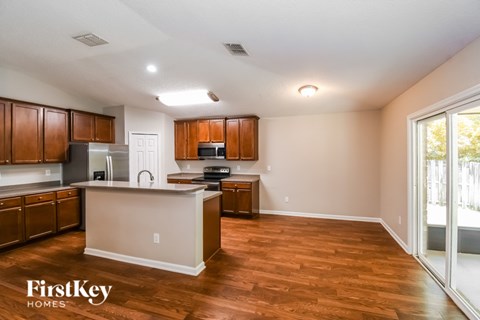 A kitchen with wooden cabinets and a white island.