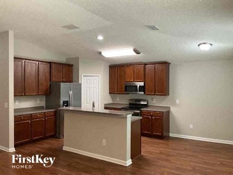 A kitchen with wooden cabinets and a white refrigerator.