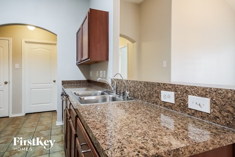 A kitchen with granite countertops and a sink.