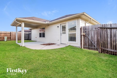 A house with a white door and a brown roof is for sale.
