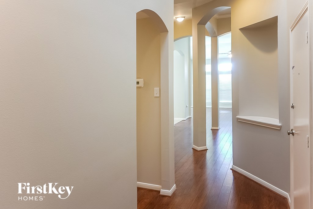 A hallway with a FirstKey Homes logo on the bottom left.