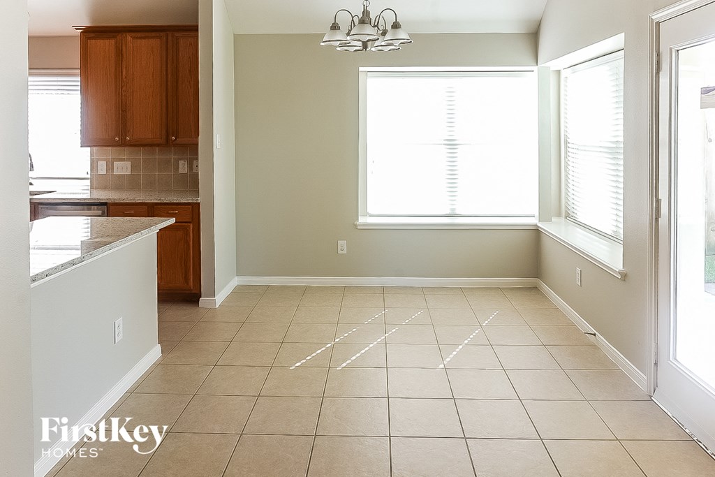 A room with a tiled floor and a chandelier.