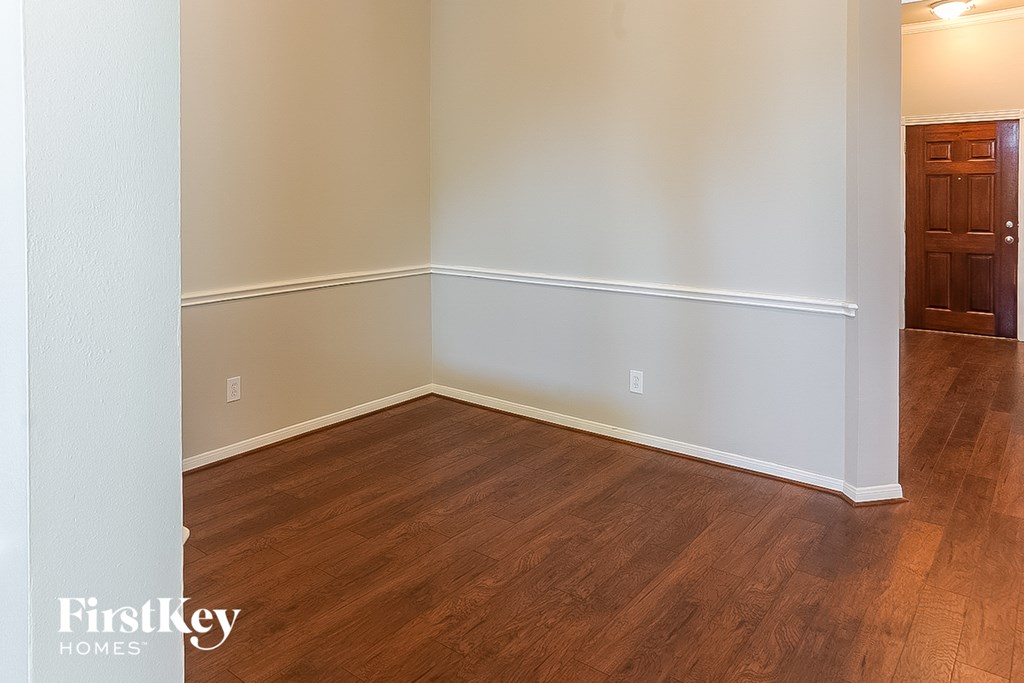 A room with wooden floors and white walls.