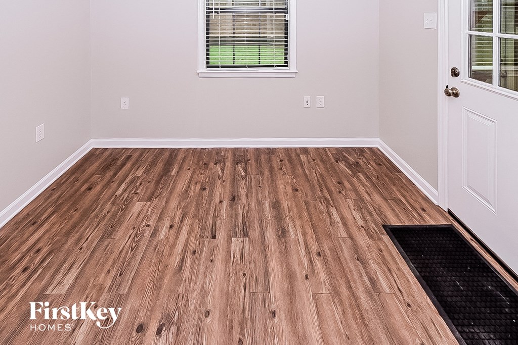 the living room of a home with wood flooring