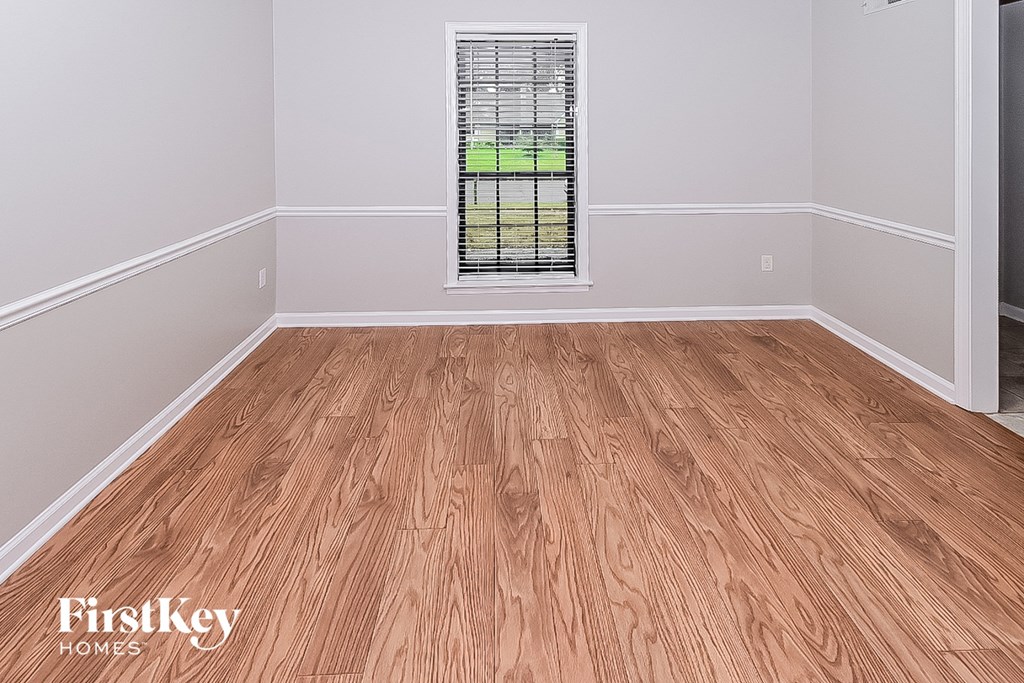 the floor of a room with wooden floors and a window