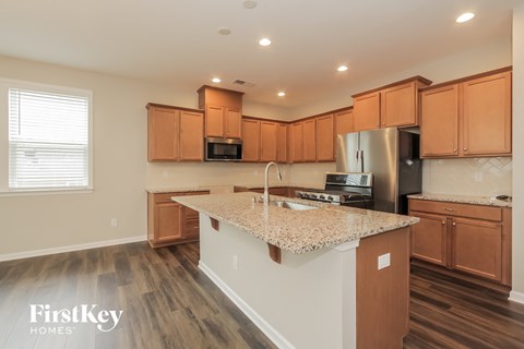A kitchen with wooden cabinets and a granite countertop.