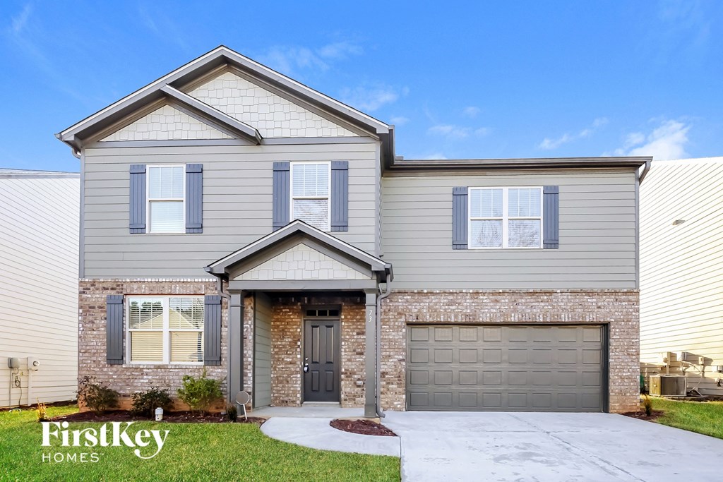 A house with a grey front and a garage door.