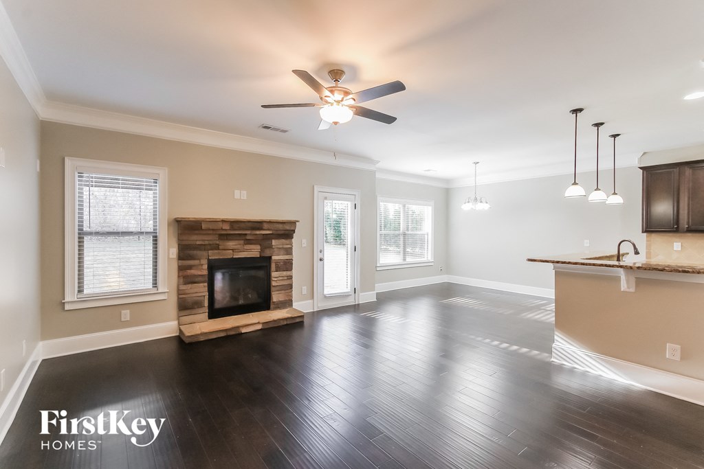 A spacious living room with a fireplace and a television.