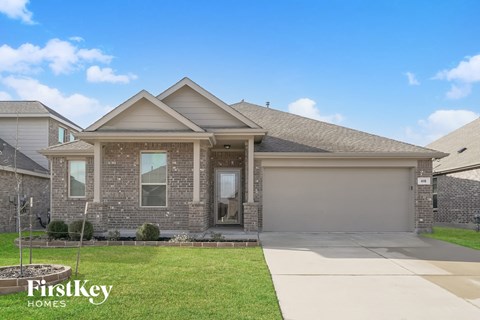 a house with a driveway and a lawn