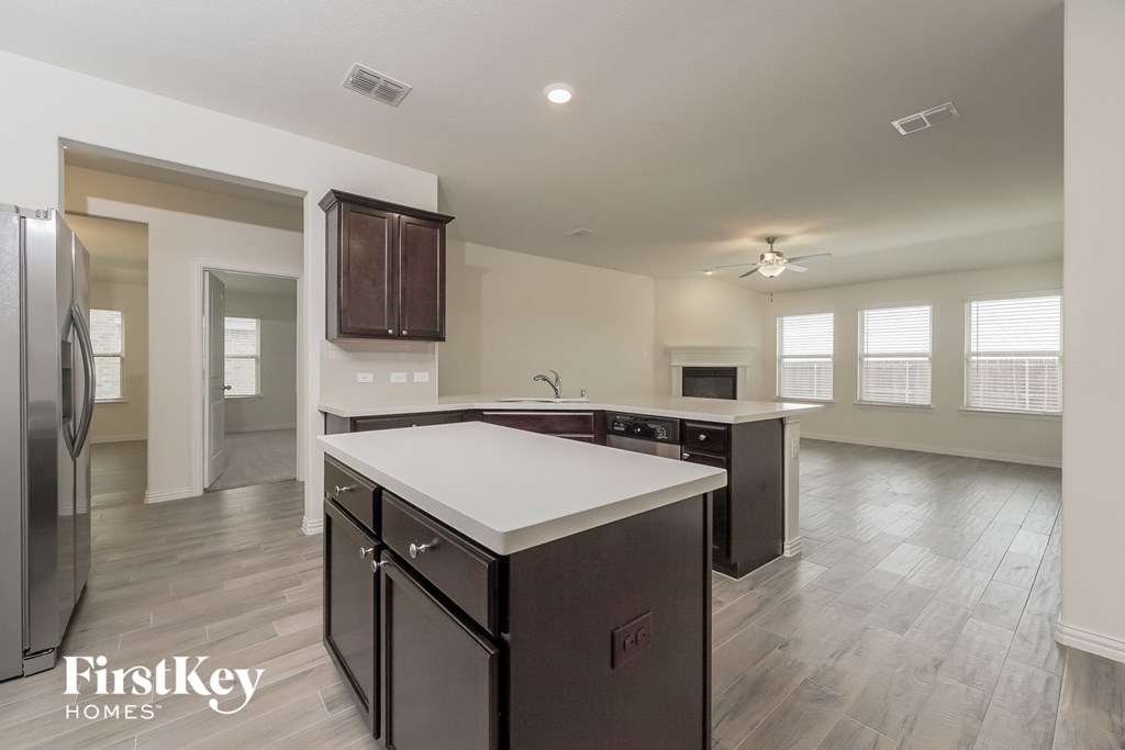 a kitchen with a white counter top in a new home