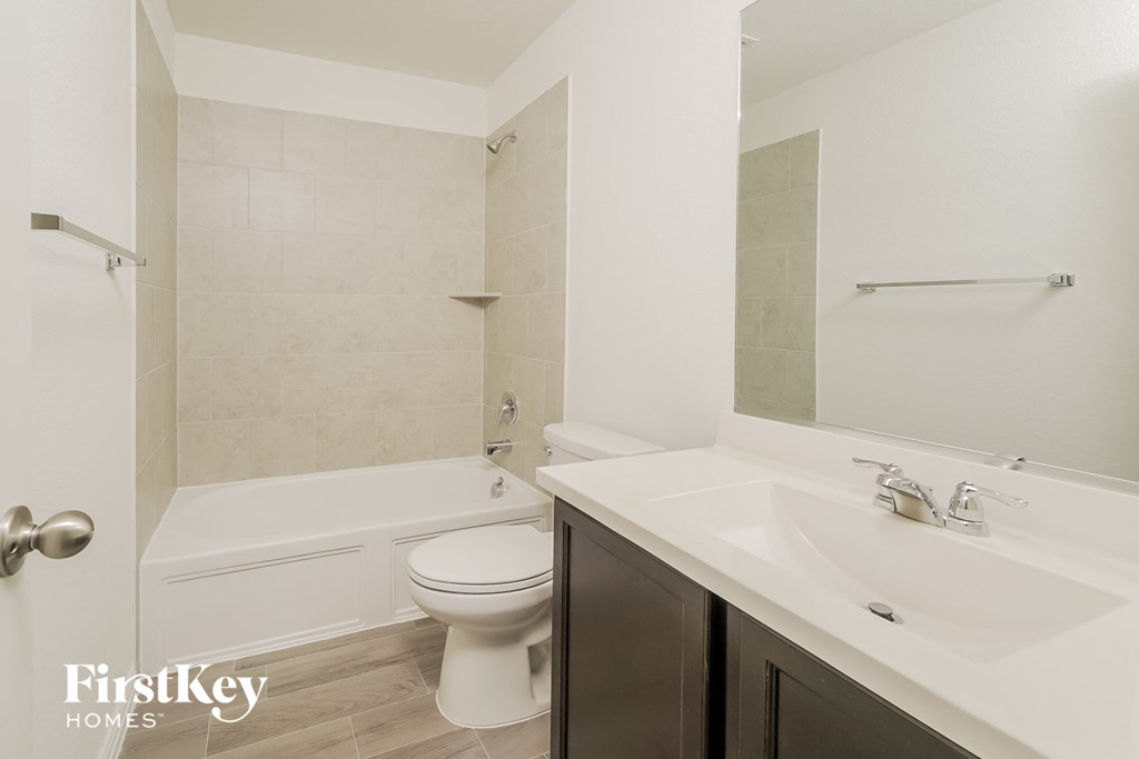 a bathroom with a sink and a toilet and a tub