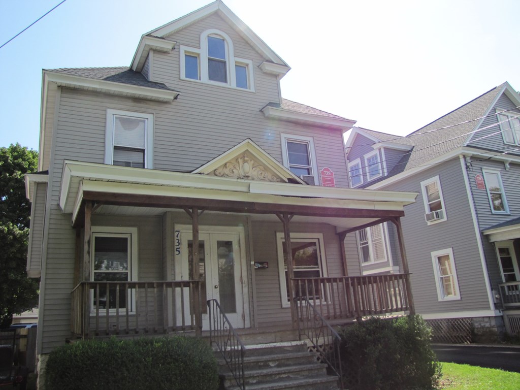 the front of a house with stairs and a porch