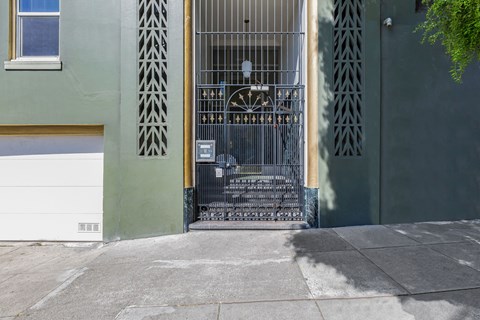 A metal gate with a decorative design is closed.