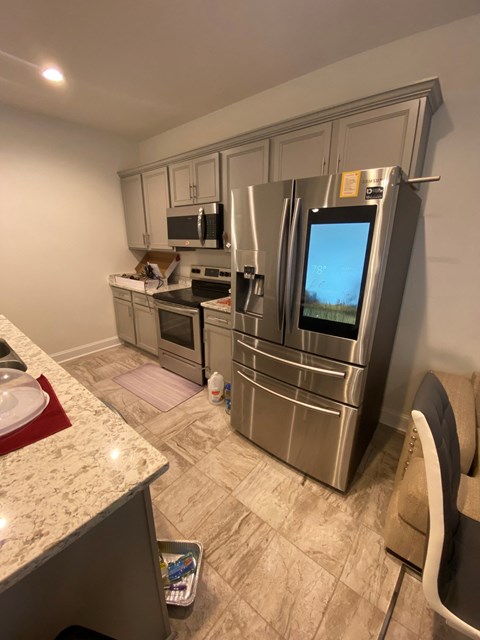 a kitchen with stainless steel appliances and a granite counter top