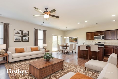 A well-lit living room with a white sofa and a wooden coffee table.