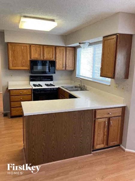 A kitchen with wooden cabinets and a white countertop.