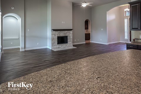 a living room with a rug and a fireplace