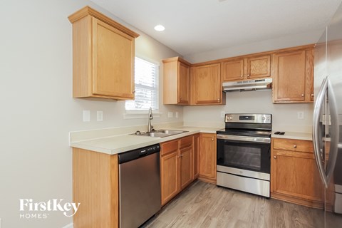 a kitchen with wooden cabinets and stainless steel appliances