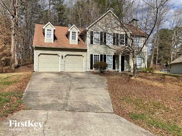 A two-story house with a garage is for sale.