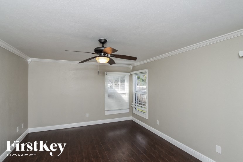 a living room with a ceiling fan and a window