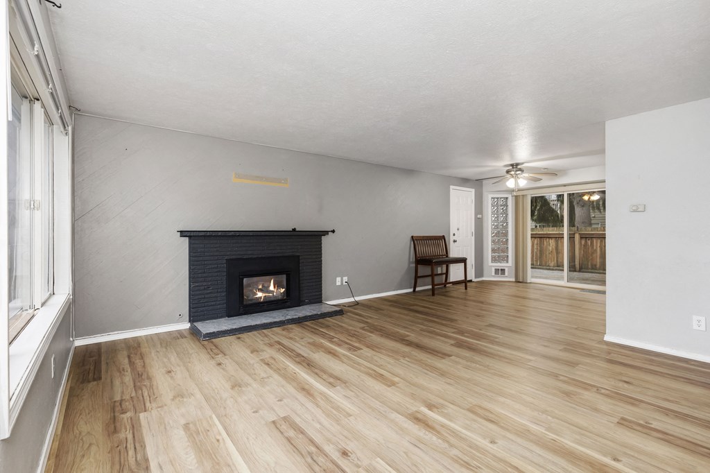 a living room with a fireplace and a wooden floor
