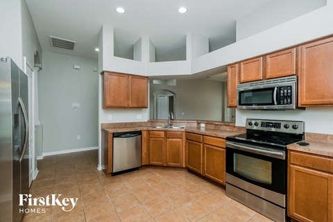 full kitchen with stainless steel appliances and wooden cabinets