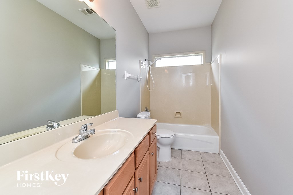A bathroom with a sink, toilet, and bathtub.