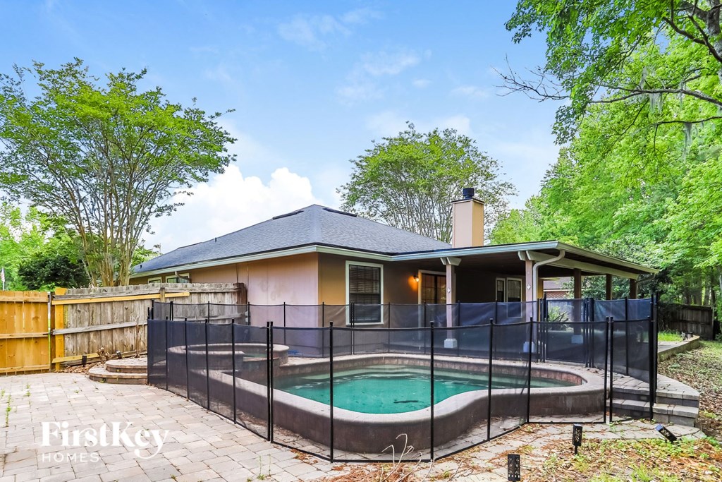 A house with a pool in the backyard.