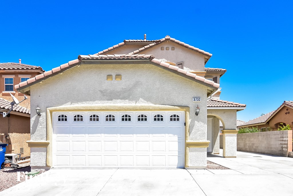 a house with a white garage door in front of it