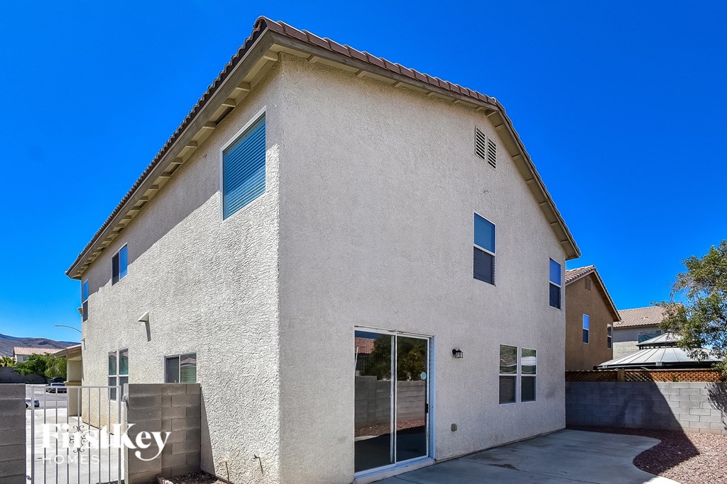 a white brick house with a big glass door