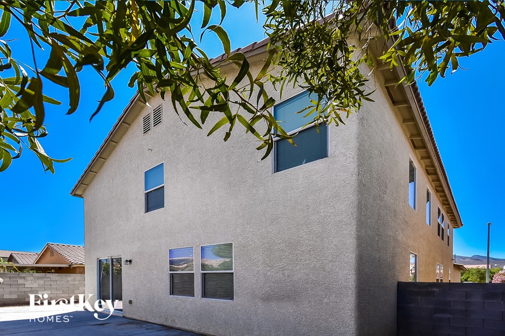 a white house with a tree in front of it