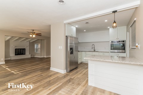A kitchen with a white counter and stainless steel appliances.