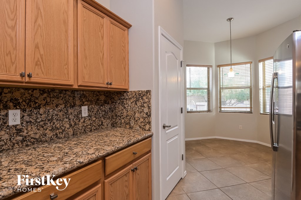 a kitchen with granite counter tops and wooden cabinets