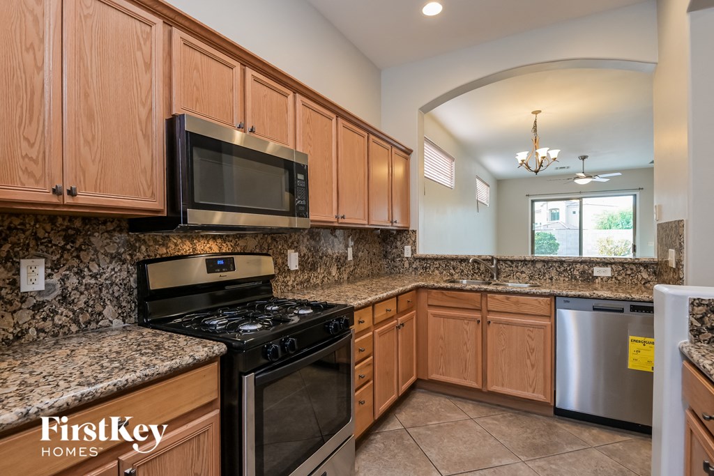 full kitchen with granite counter tops and stainless steel appliances