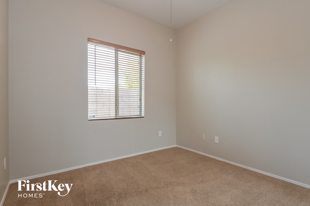a carpeted room with a window and a window