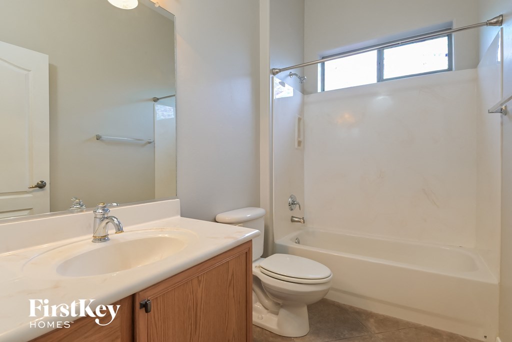 an empty bathroom with a sink toilet and shower