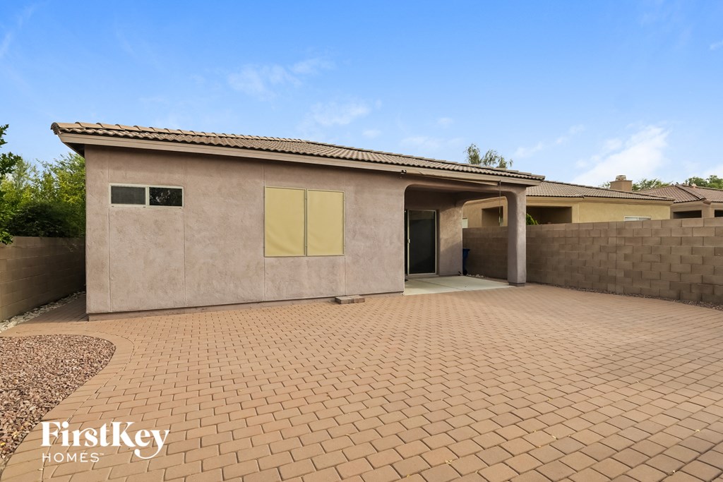 a house with a brick driveway and a garage door