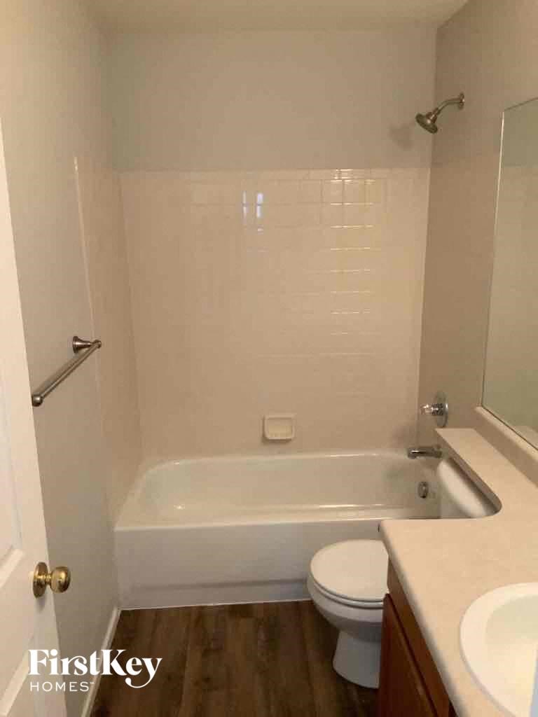 a small bathroom with a toilet and a tub and a sink