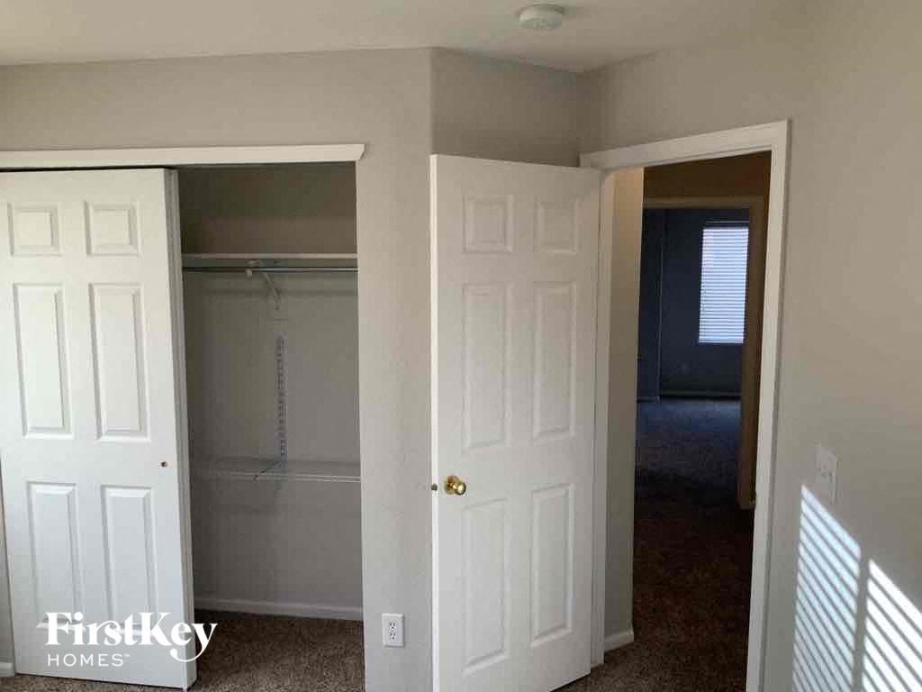 an empty closet in a room with a closet door and a closet