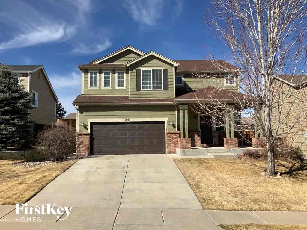 a large house with a garage door in front of it