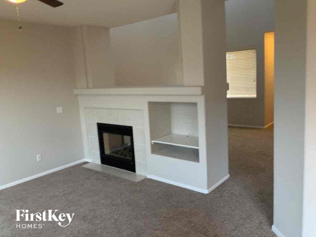 an empty living room with a fireplace