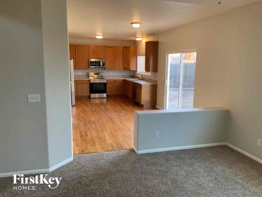 an empty living room and kitchen in an empty house
