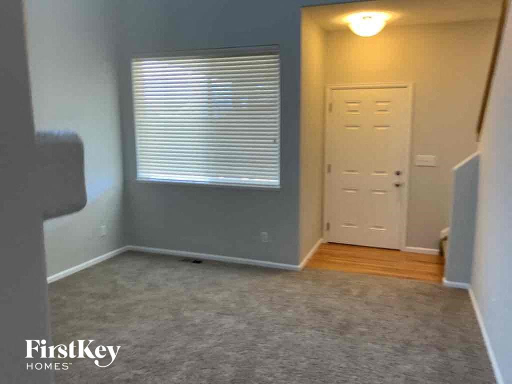 a room with a door and a window and a carpet