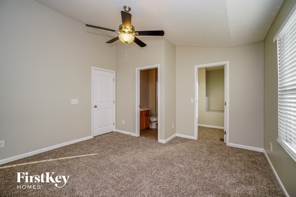 the master bedroom is spacious and has a ceiling fan