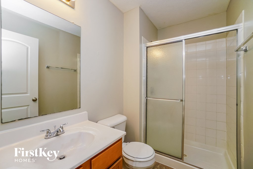 a bathroom with a shower toilet and sink
