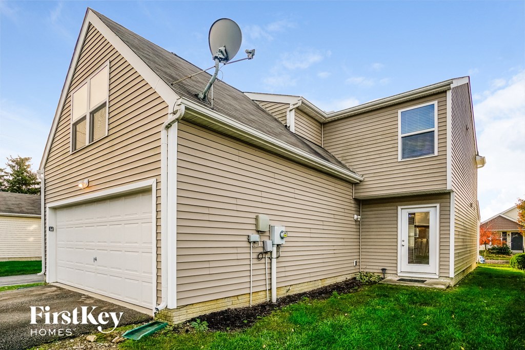 a side view of a house with a satellite dish on top of it