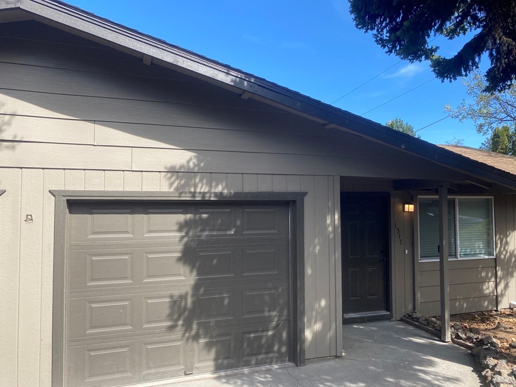 the front of a house with two garage doors